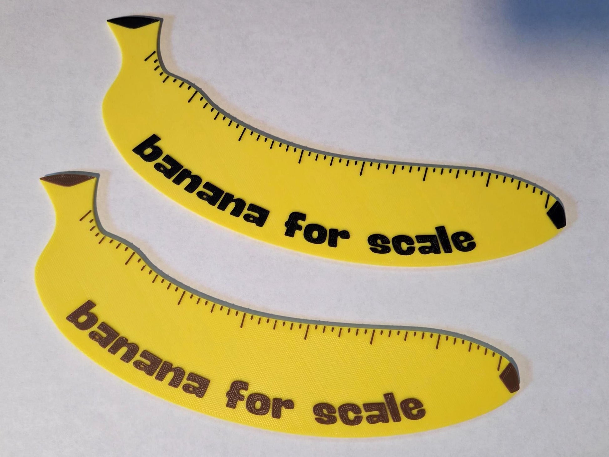 Two yellow banana-shaped rulers with 'banana for scale' in black and brown text on a white background